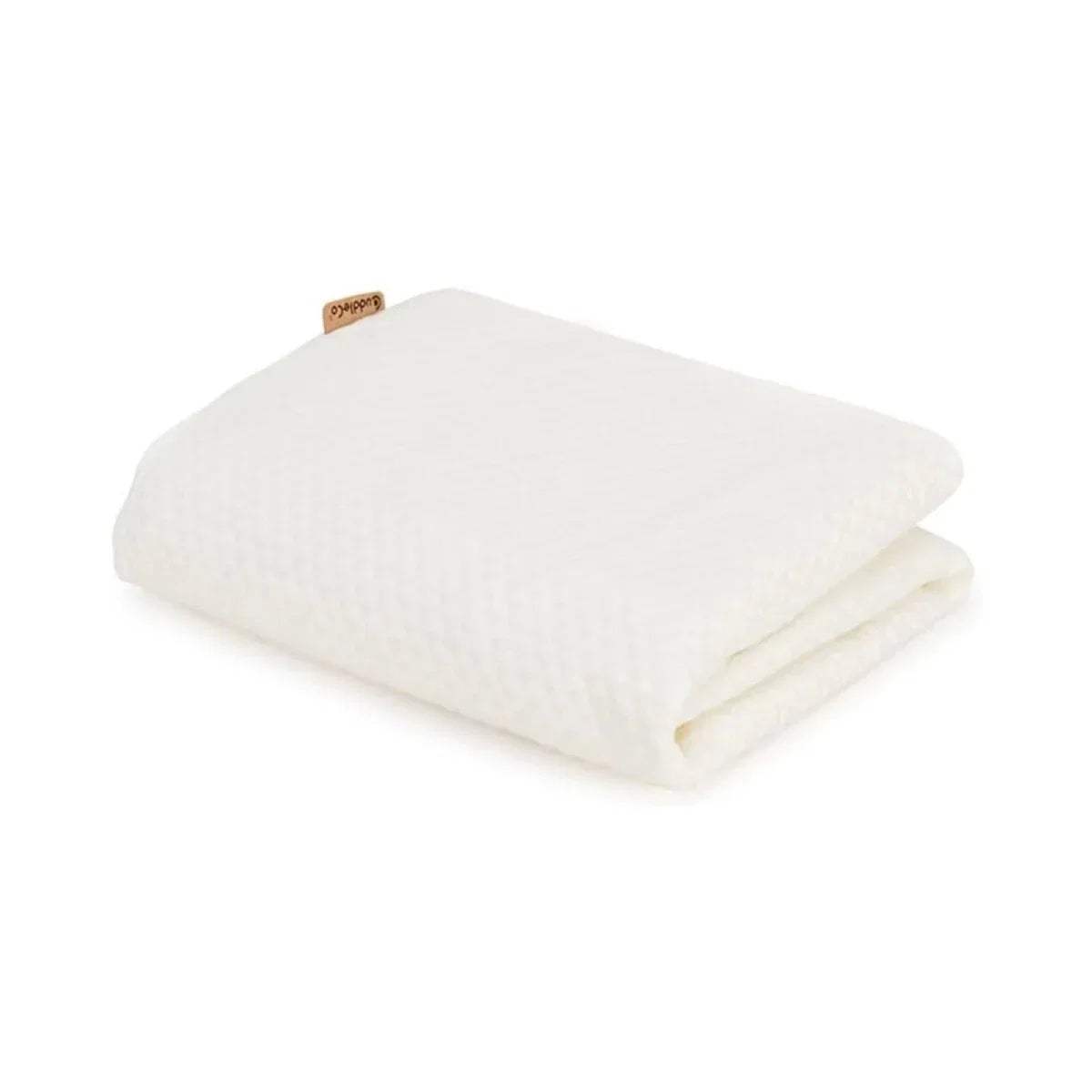 White cot bed waterproof mattress protector, folded blanket-style with stitched edges.