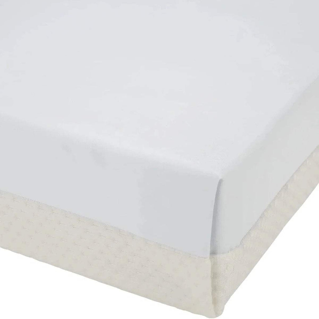 White cot bed mattress with neatly stitched fabric sides and rounded corner.