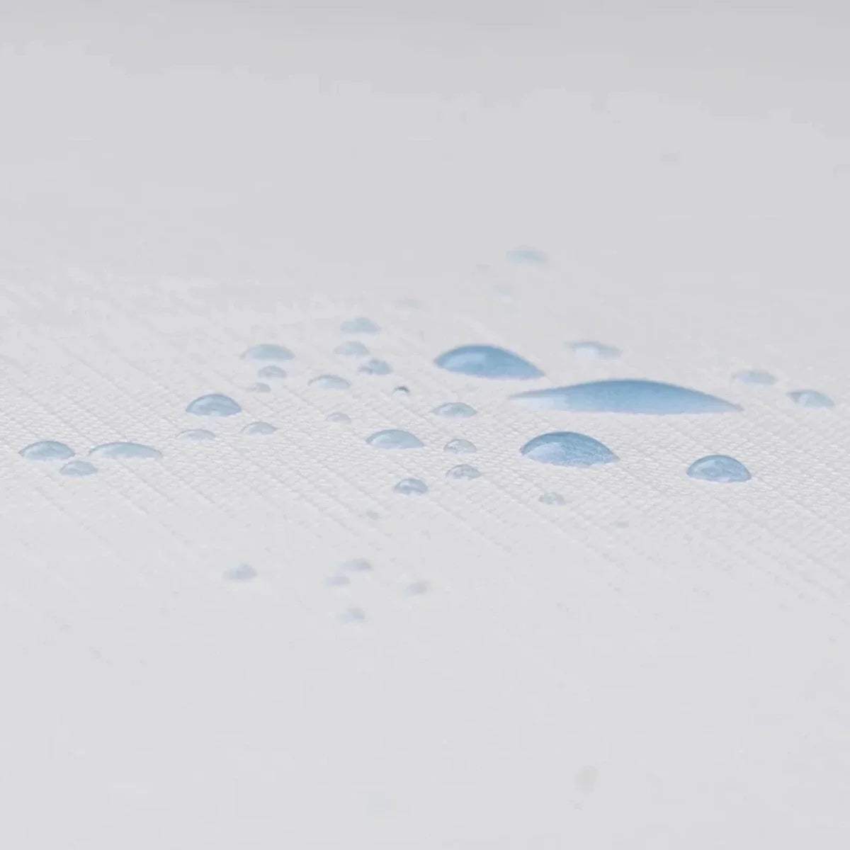 White waterproof training cover with blue droplet pattern, close-up.