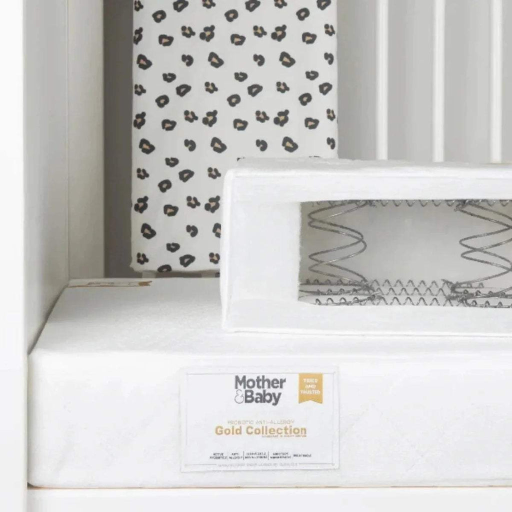 White anti-allergy sprung cot bed mattress with brand label on front panel