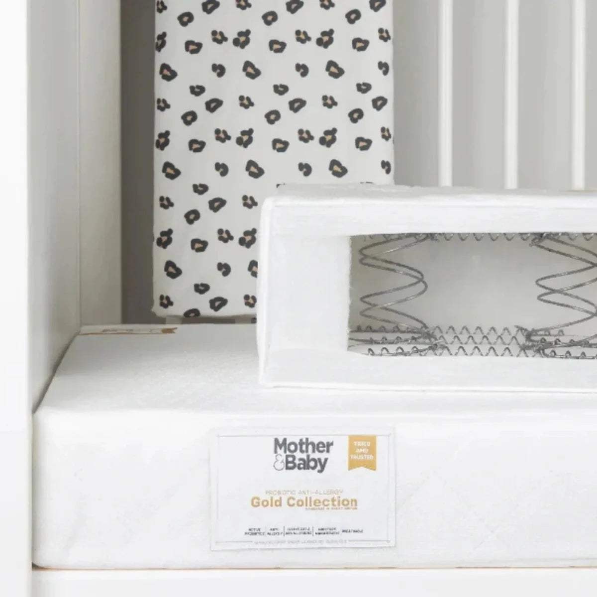 White anti-allergy sprung cot bed mattress with brand label on front panel