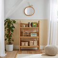 Rattan-style 3-tier shelving unit with open shelves for books and baskets