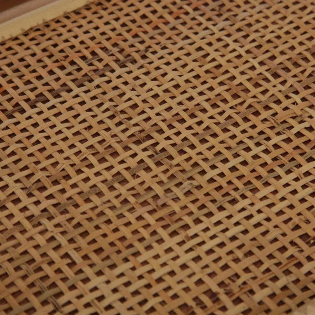 Close-up of woven rattan mesh shelf panel in natural tan color