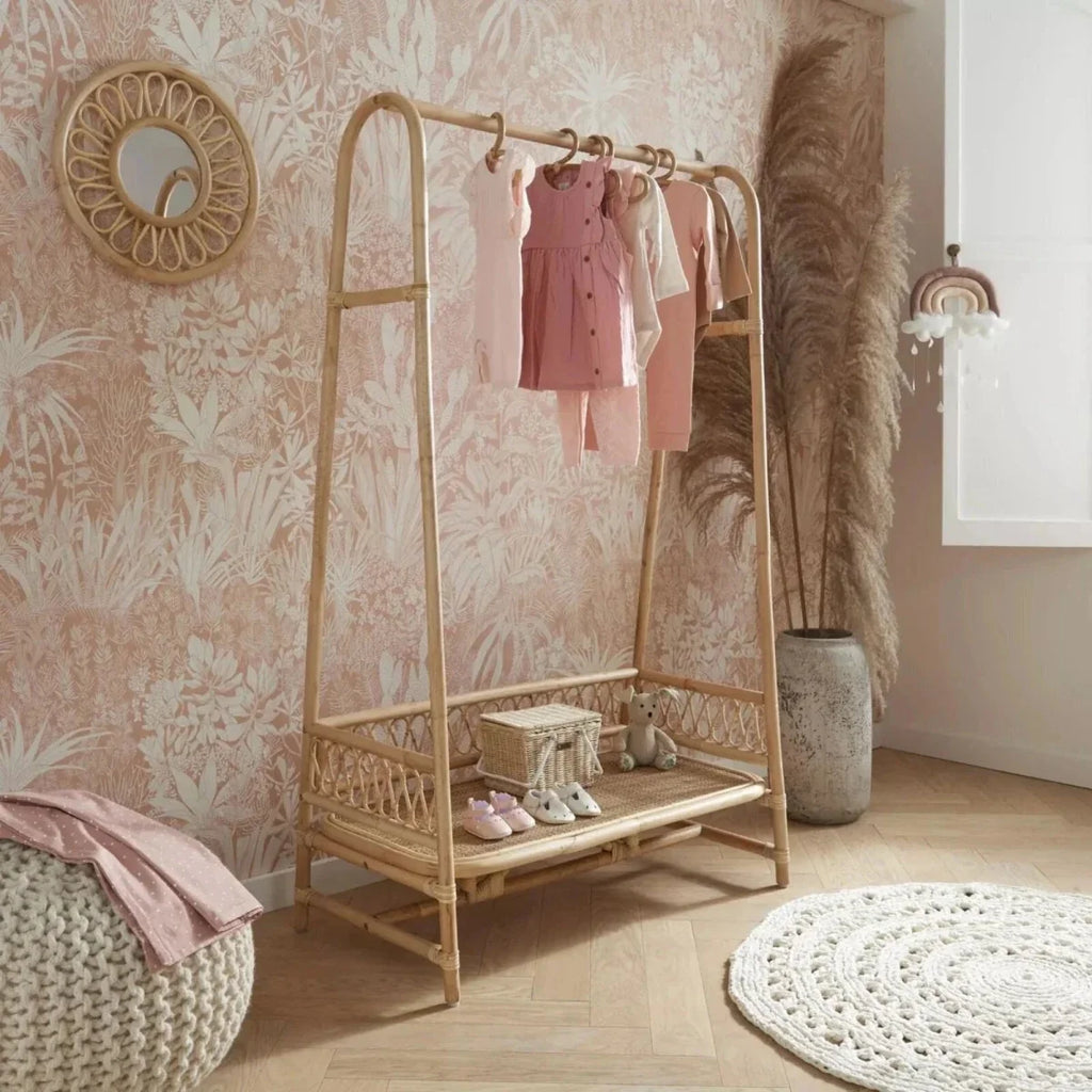 Children's rattan clothes rail with hanging bar, lower shelf, and open frame in light natural.
