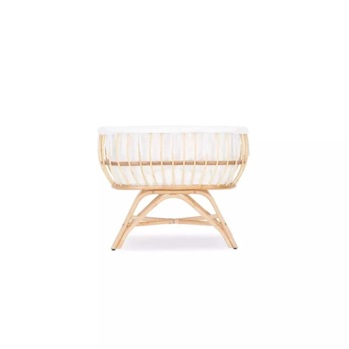 Natural rattan baby crib with white fabric bedding and cross-legged base