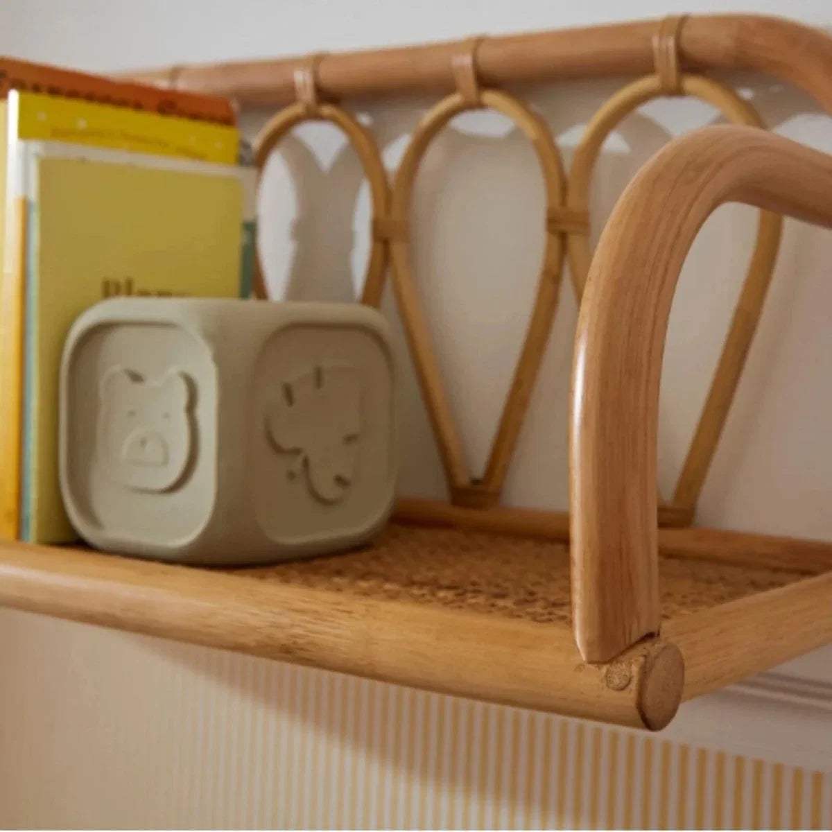 Small rattan shelf close-up with arched looped back and rounded front corner