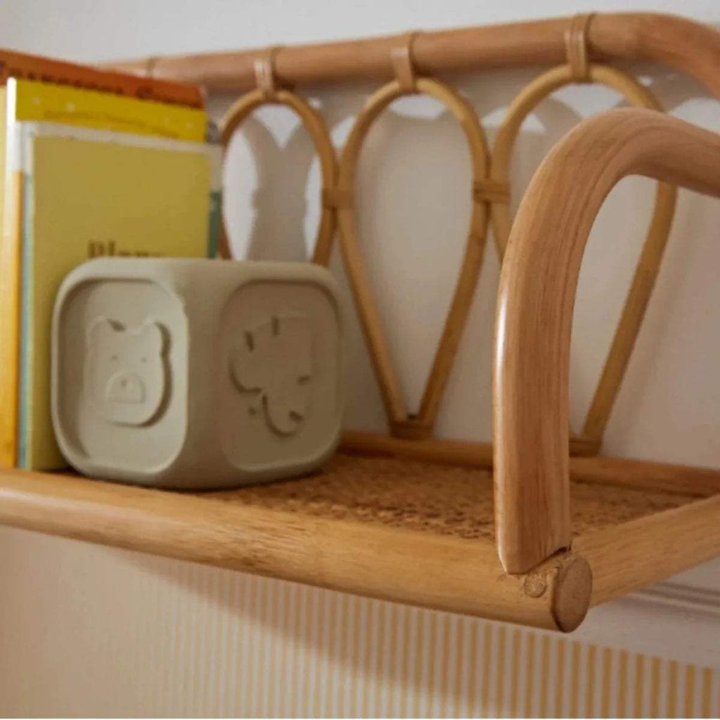 Rattan shelf with arched side supports and curved top railing