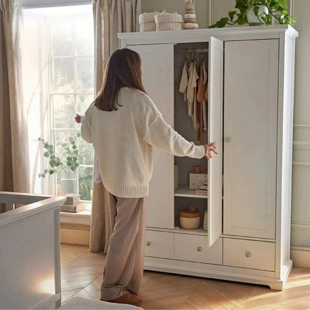 White wardrobe cabinet with one door open, showing inner shelves and hanging space