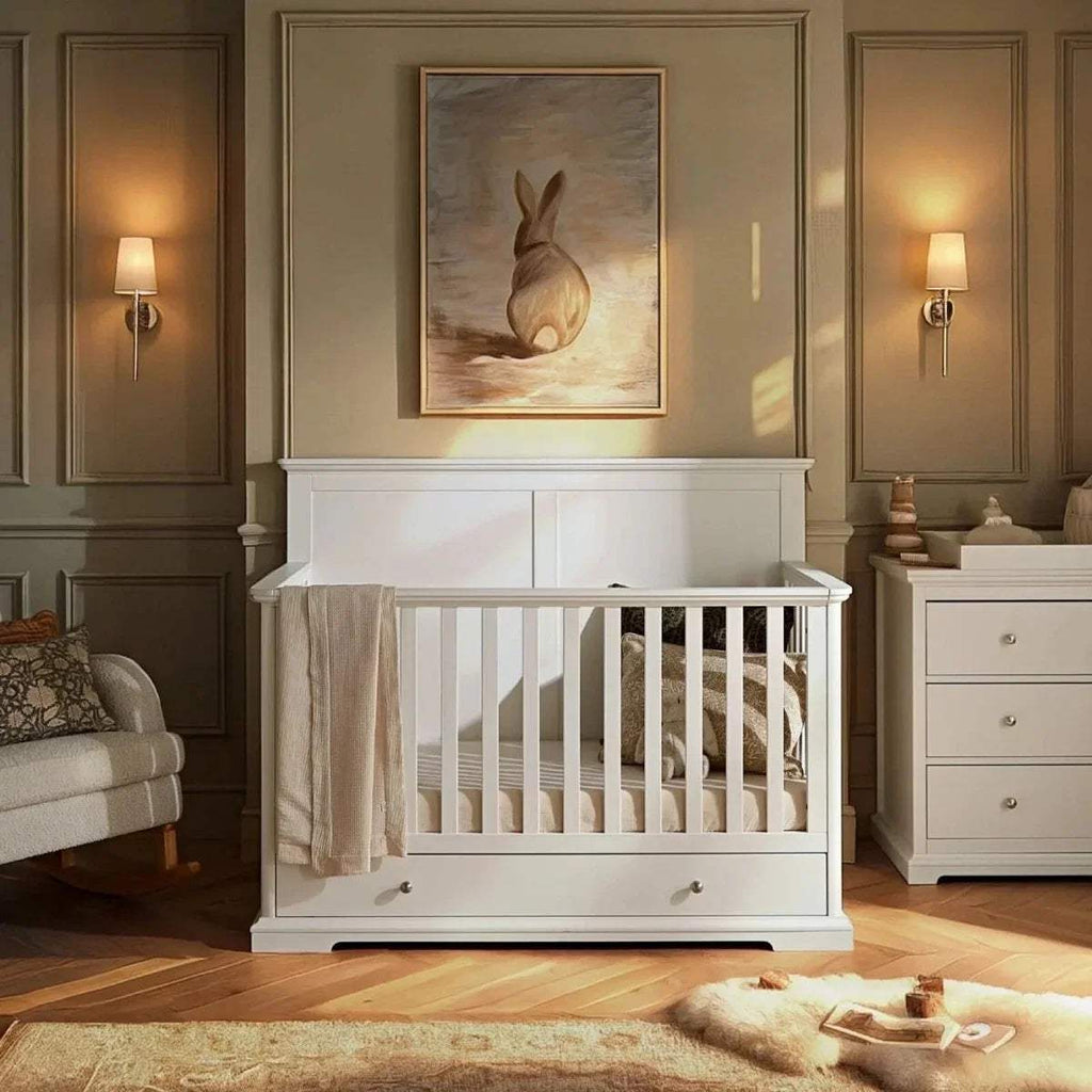 White cot bed with vertical slat rails and under-drawer storage