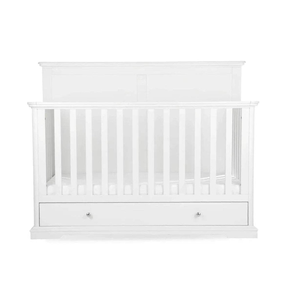 White cot bed with vertical slat guard rails and paneled ends