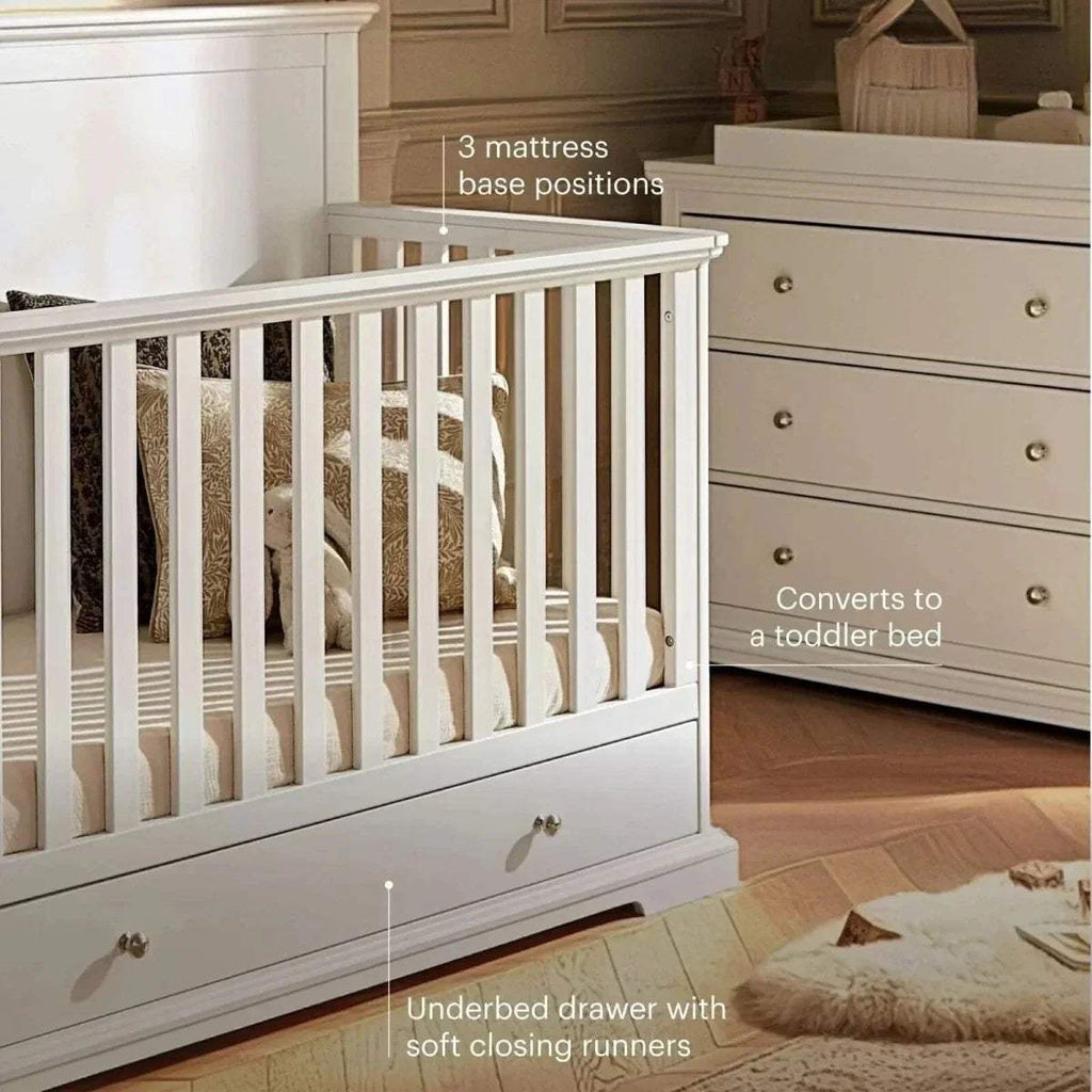 White cot bed with slatted guard rails and underbed drawer
