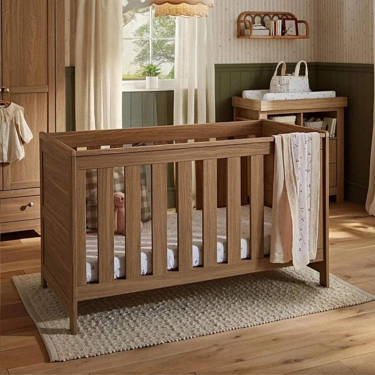 Oak cot bed with slatted sides and solid corner posts