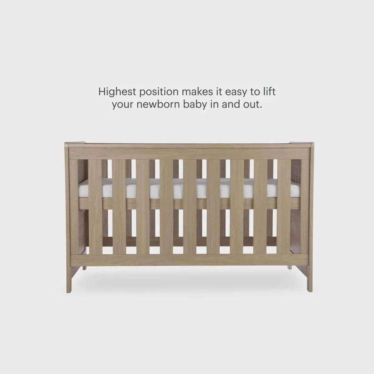 Oak cot bed front with vertical safety slats and raised end rails