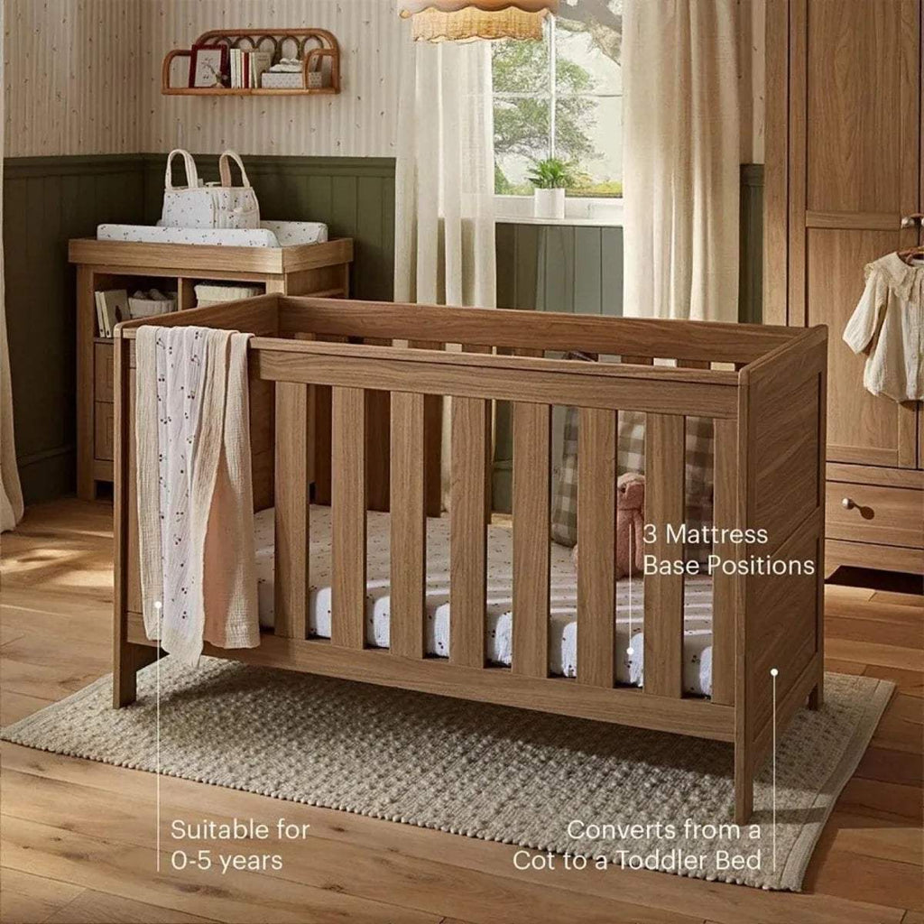 Oak cot bed with slatted guard rails and open end panels