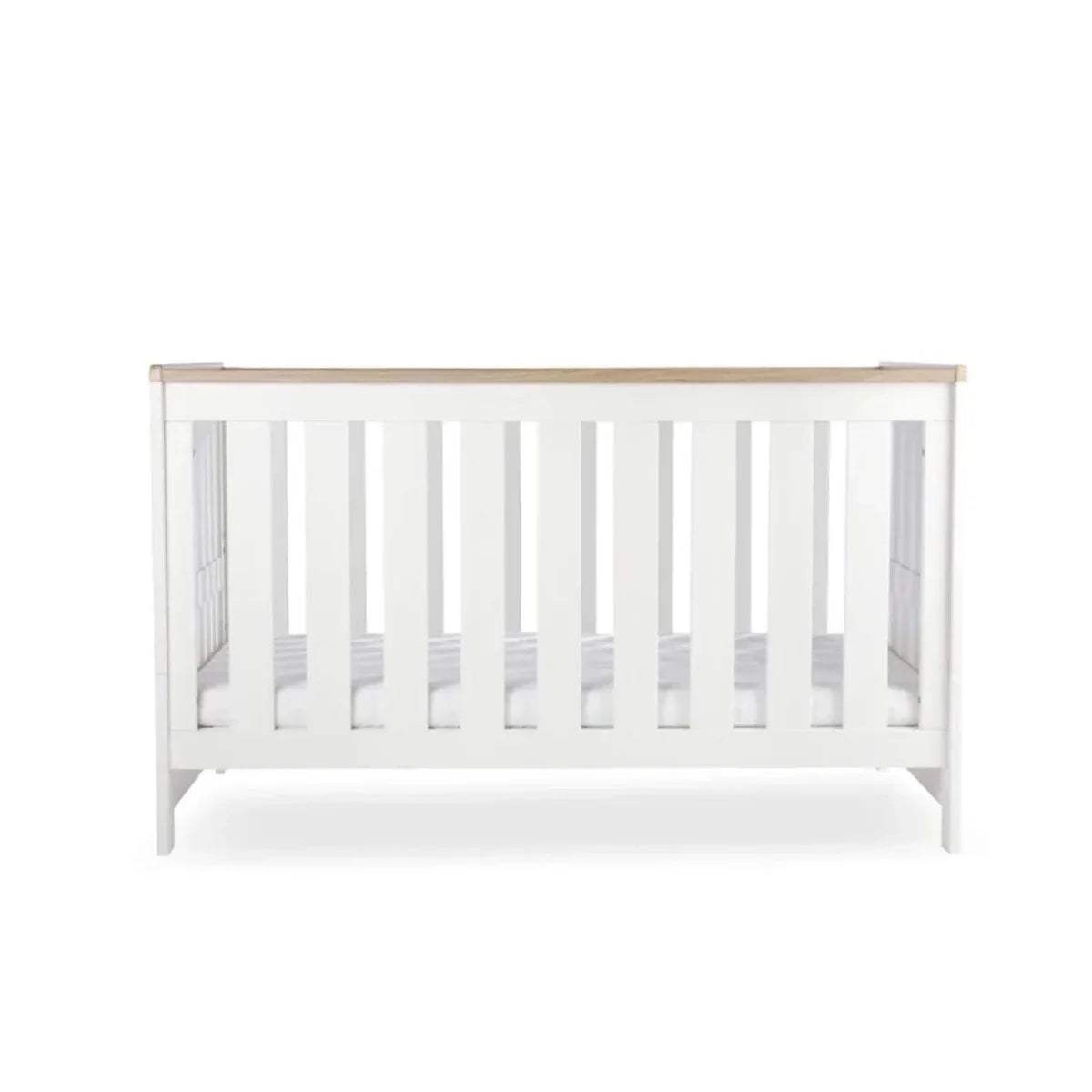 White cot bed front view with vertical slats and oak-toned top rail