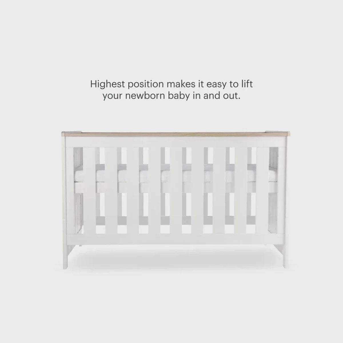 White cot bed end panel with vertical slats and oak-toned top rail