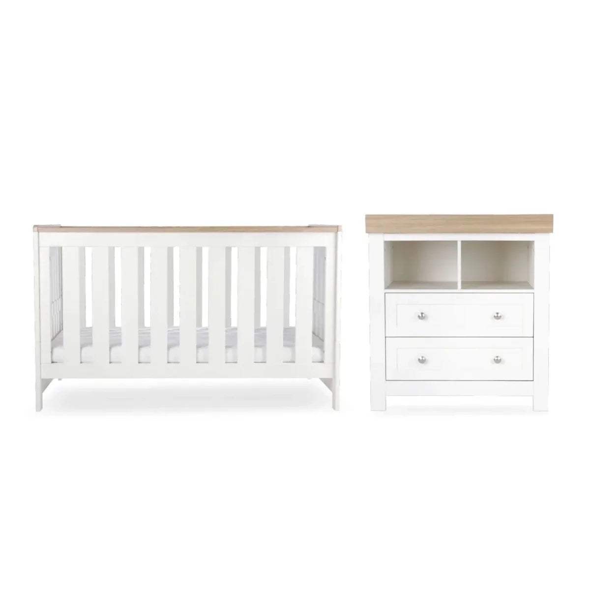 White nursery cot and matching dresser with drawer fronts and open shelves