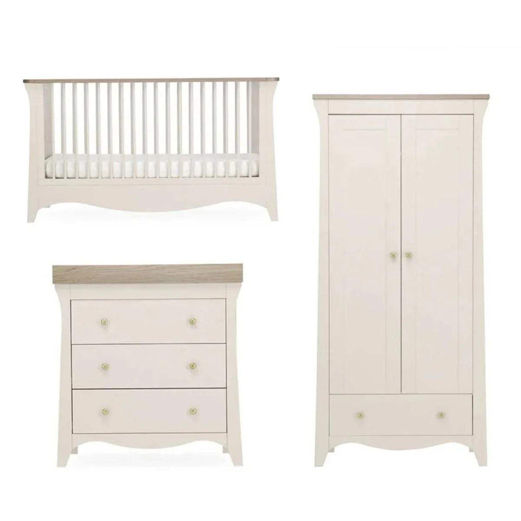 White nursery furniture set: crib, 3-drawer dresser, and wardrobe cabinet