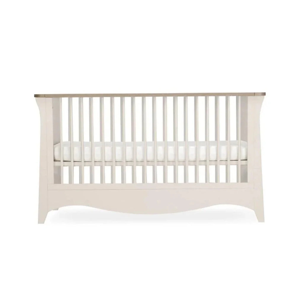 White nursery crib with vertical slat guard rails, centered front view