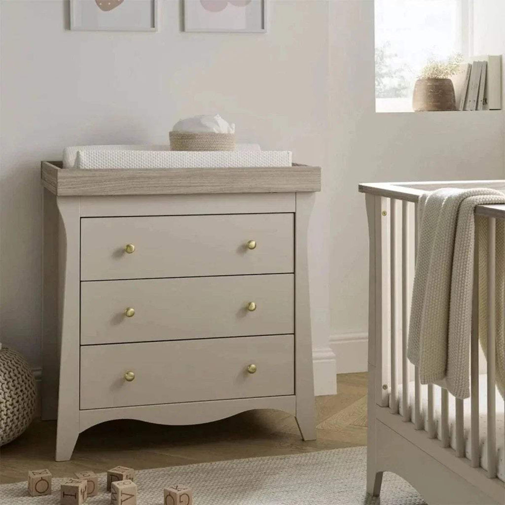 White dresser changer with three drawers and gold knob handles