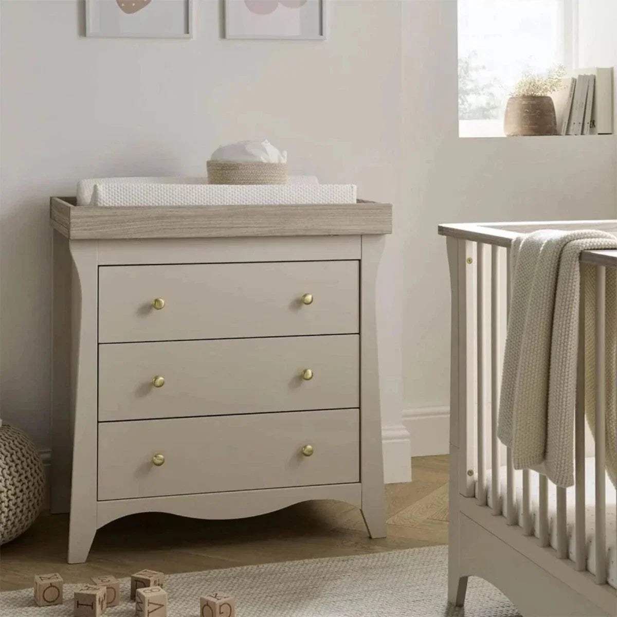 White dresser changer with three drawers and gold knob handles