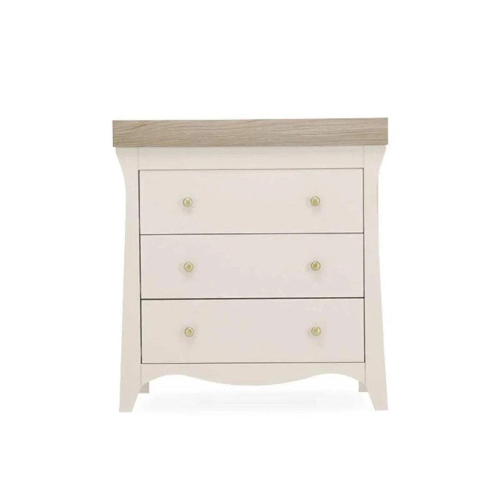White dresser changer with flat top, three drawer fronts, and gold knobs
