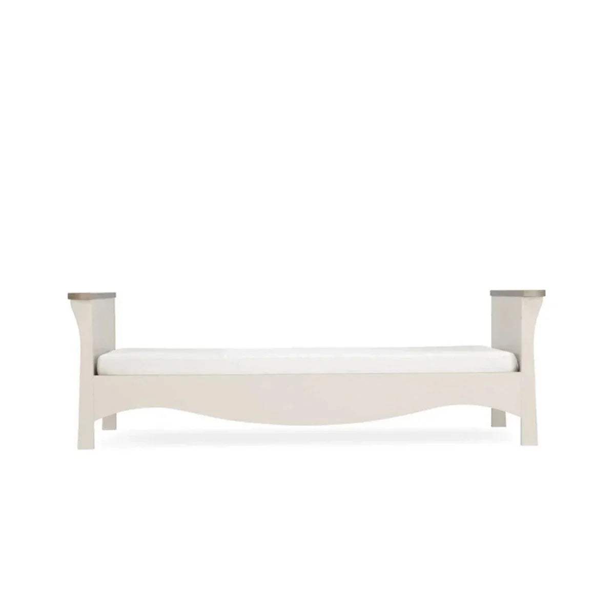 White cot bed frame with curved silhouette and low side rails