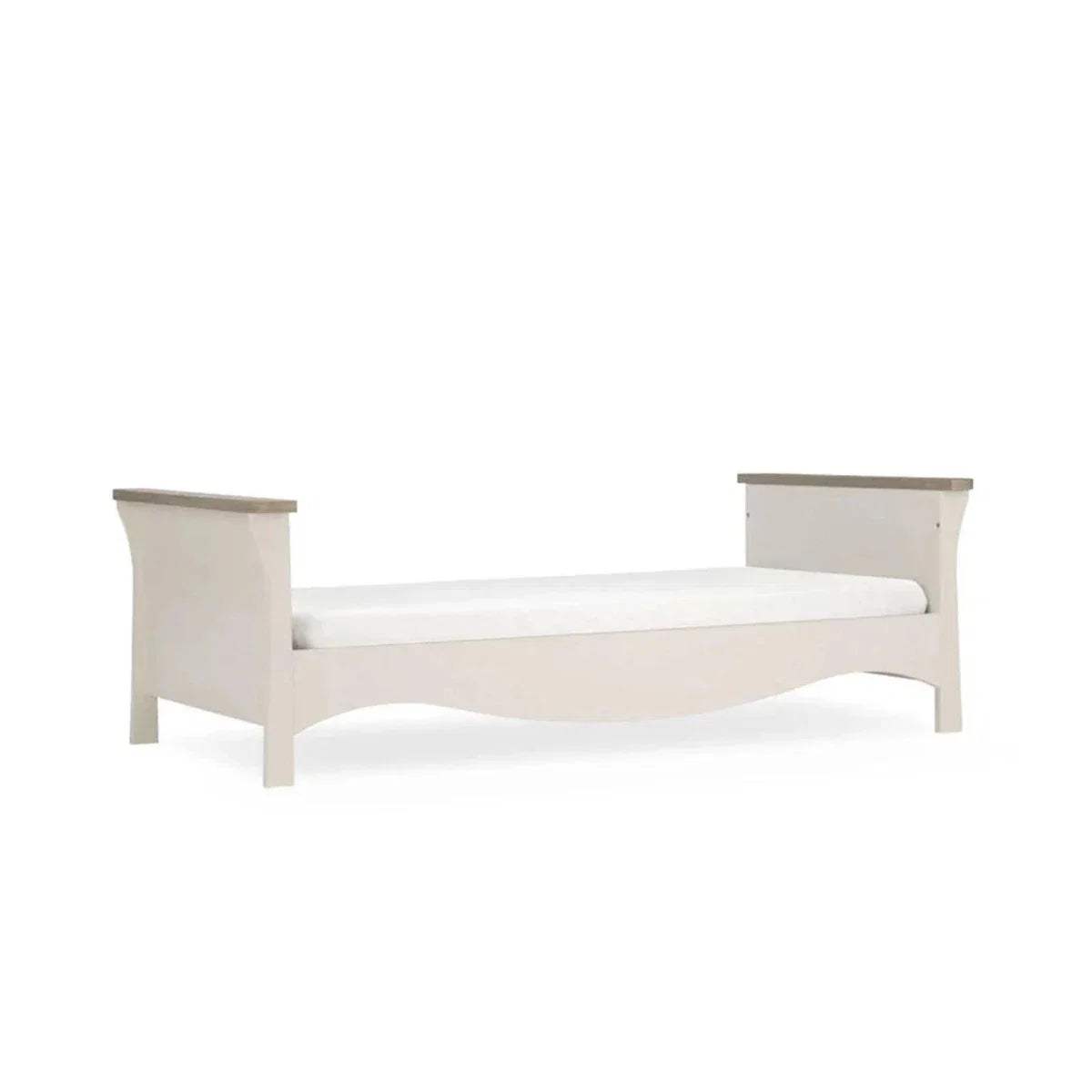 White cot bed with curved ends and raised side rails, angled view