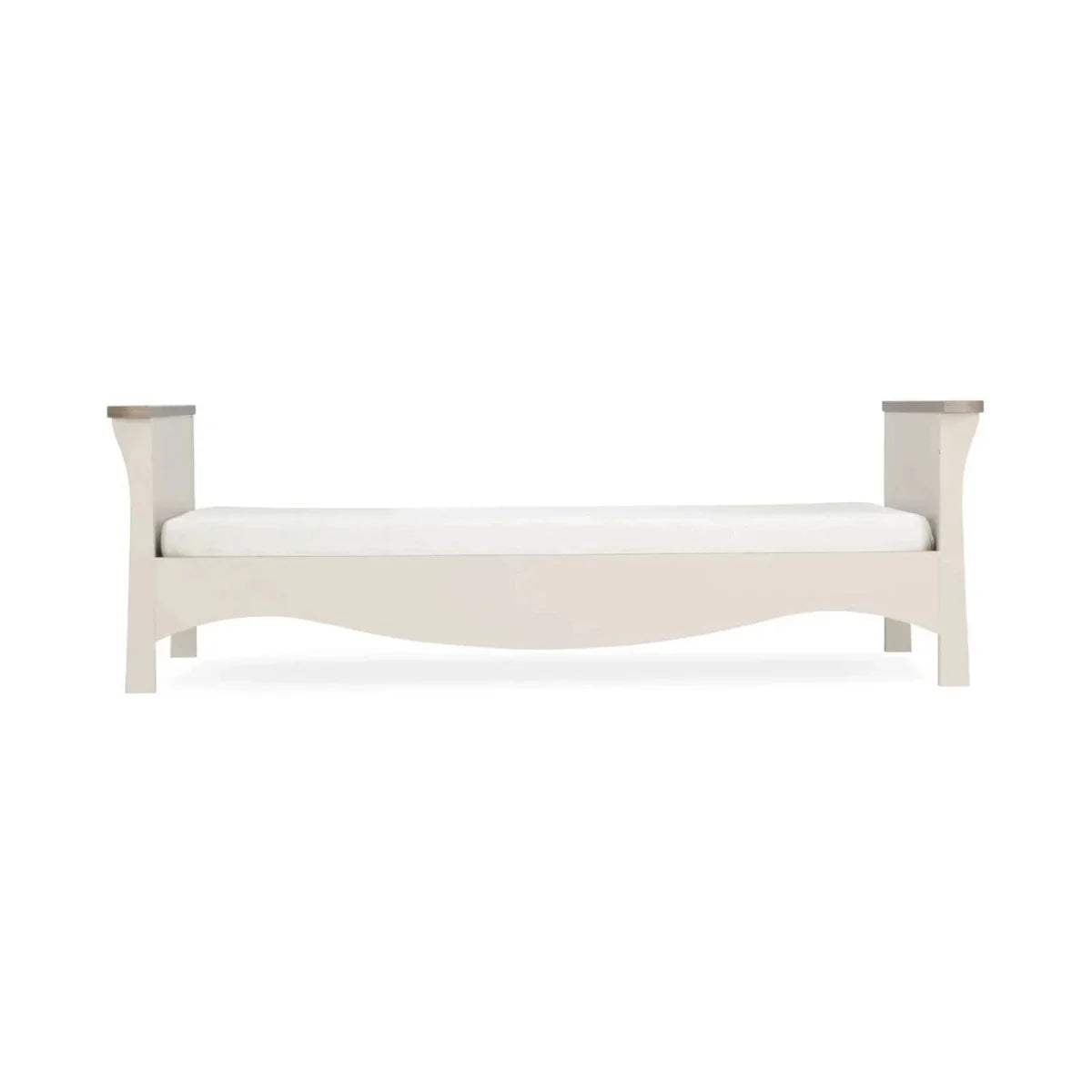 Cream toddler bed frame with slatted sides and low footboard, simple paneled design