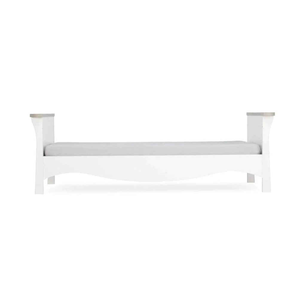 White toddler bed frame with side rails and corner posts