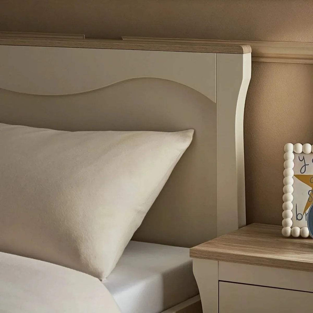 Cashmere-ash single bed headboard with white pillow and smooth upholstery