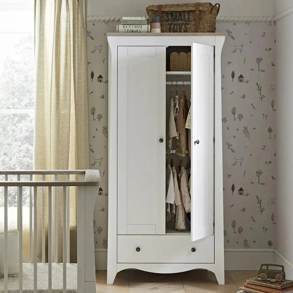 White nursery wardrobe with two doors and open interior storage shelves