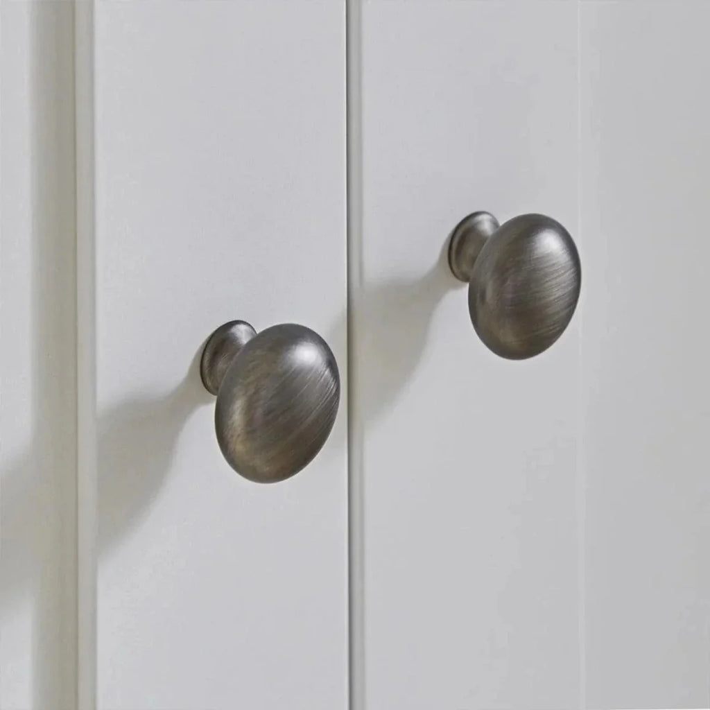 White wardrobe doors with brushed metal knob handles