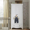 White 2-door wardrobe with lower drawers and knobs; open front shows hanging clothes