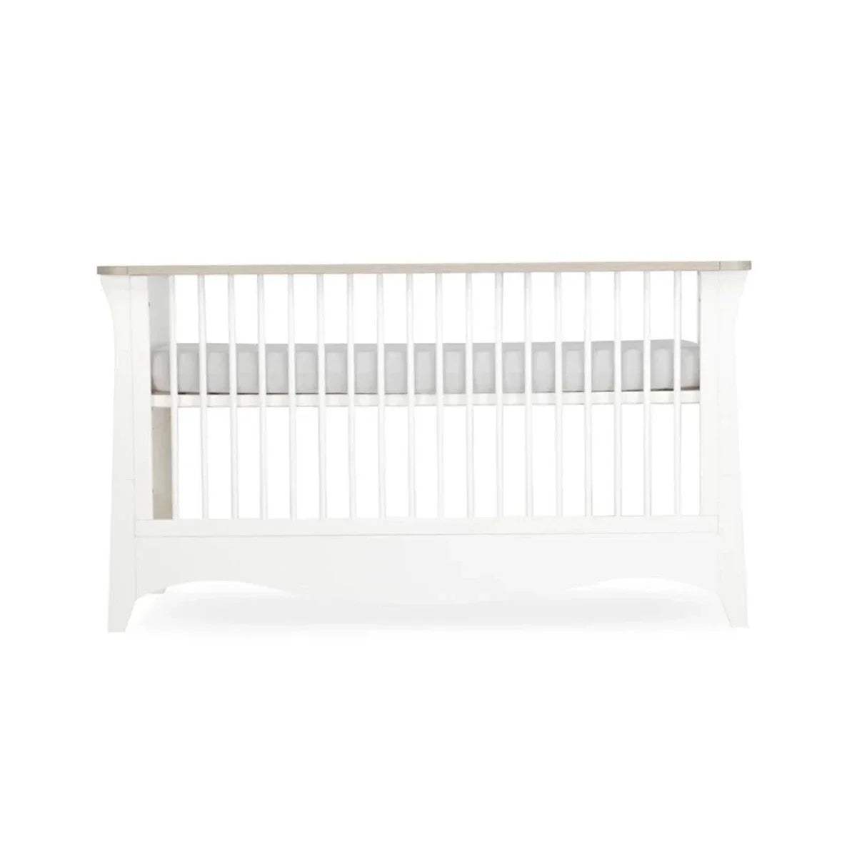 White cot bed front view with vertical slats and curved lower base