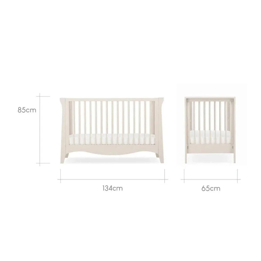 White nursery bed frame with matching small open-slat cabinet