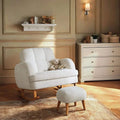 Off-white boucle nursing chair with curved wood base and matching round foot stool