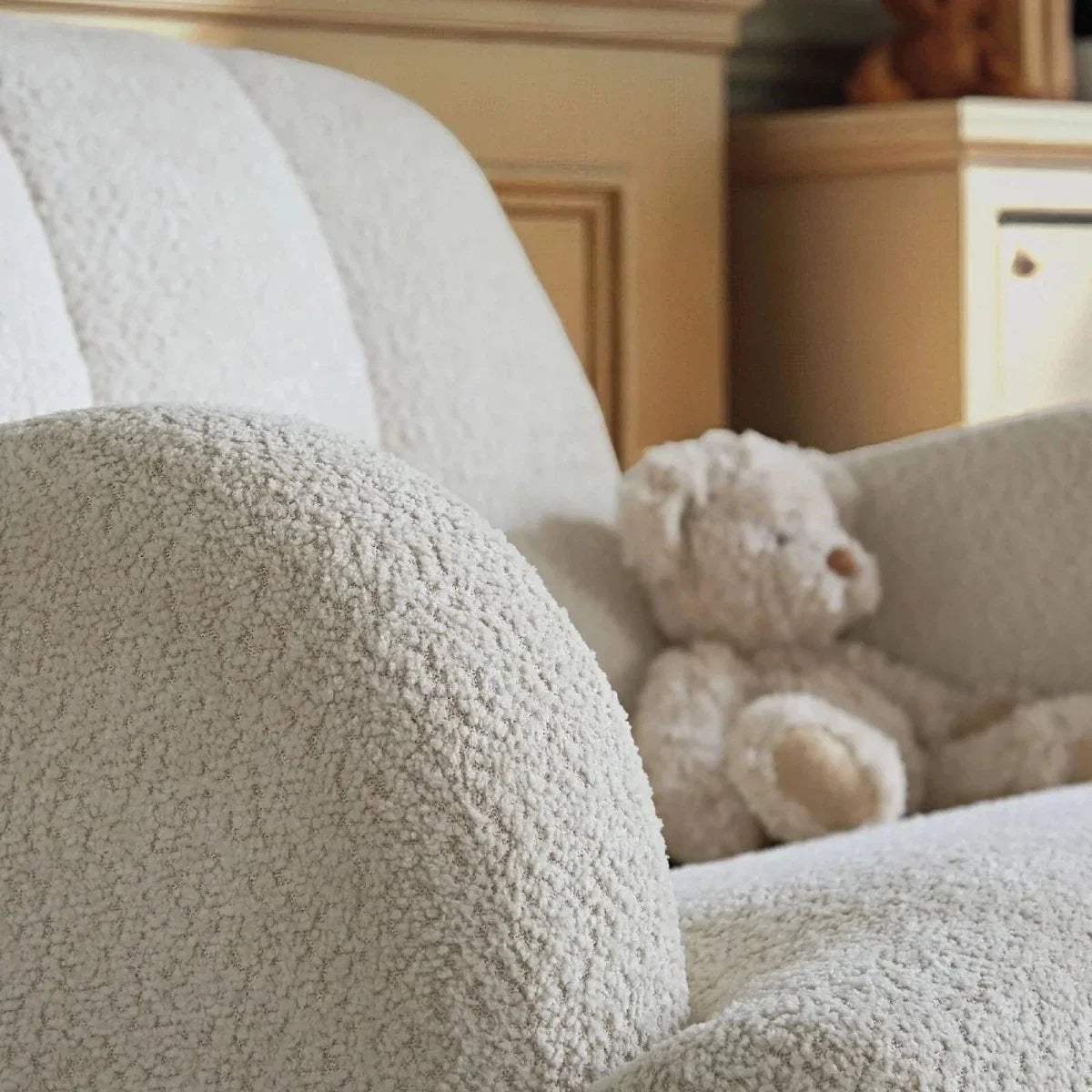 Off-white boucle nursing chair upholstery with teddy accent on the seat