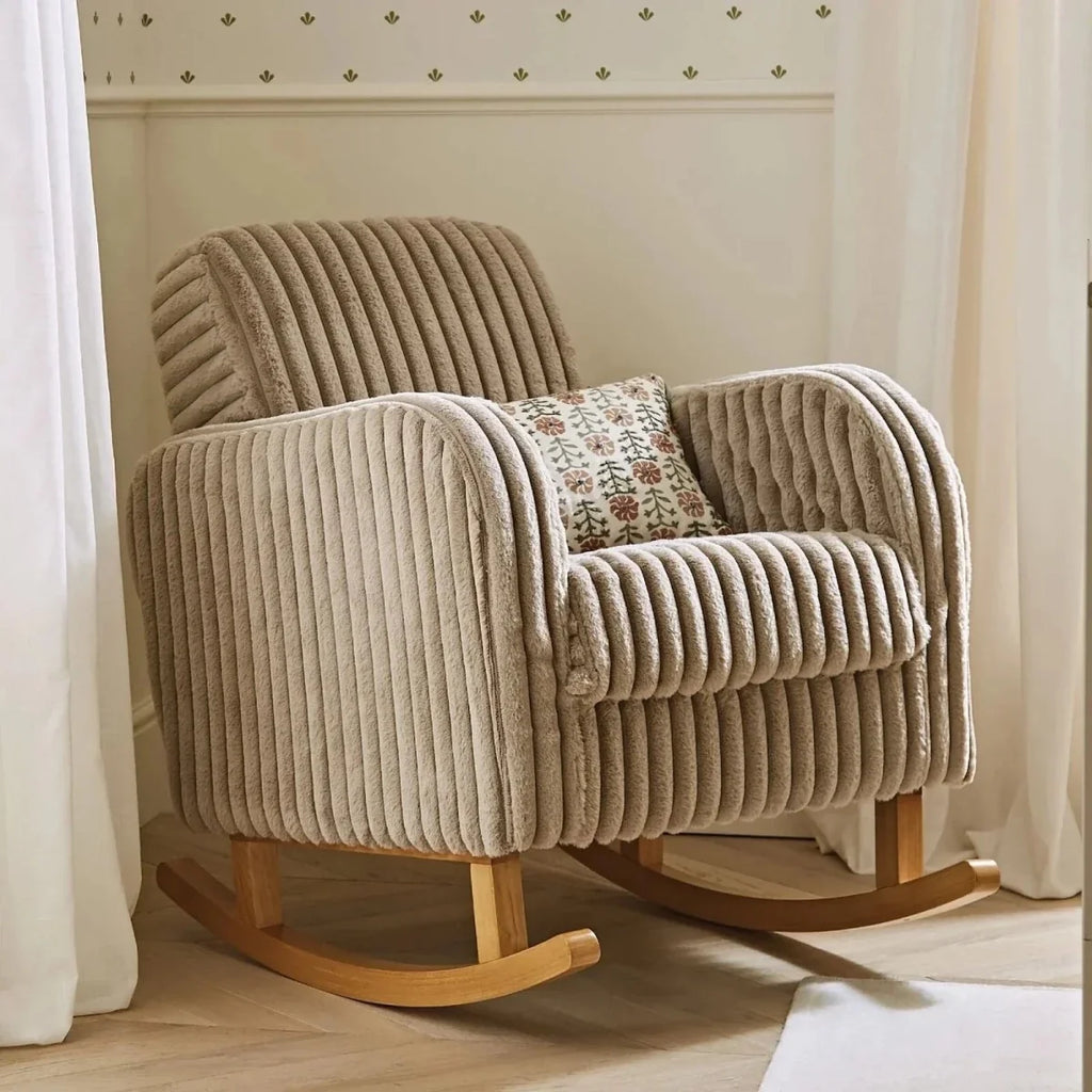 Mink faux-fur nursing chair with patterned seat cushion and matching footstool on wooden rockers.