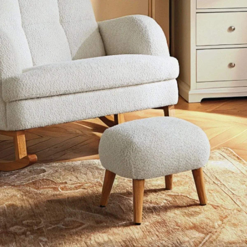 Off-white boucle foot stool with rounded seat and four wooden legs