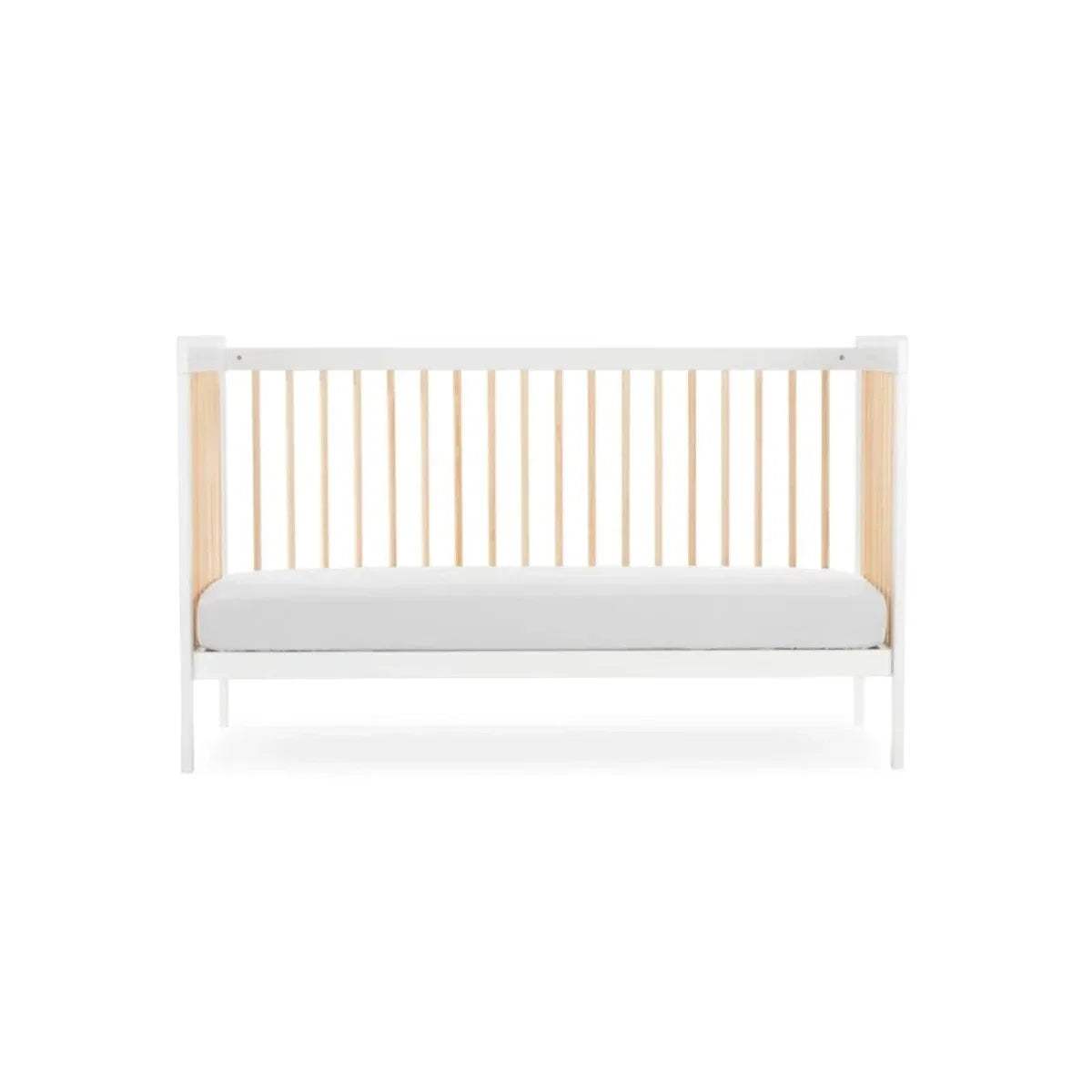 White cot bed with natural slatted back panel and light grey padded base, front view.