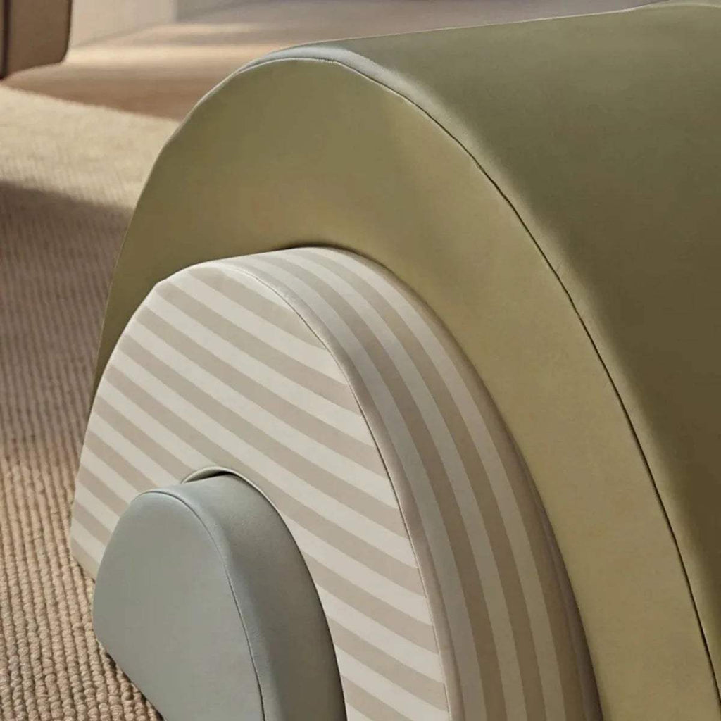Close-up of olive green foam play arch with striped inner panel and gray front