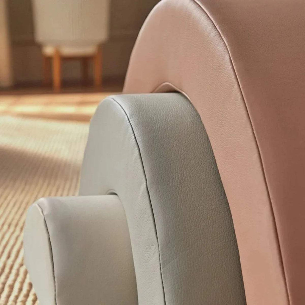 Mauve arched play cushion with smooth textured fabric and stitched seam