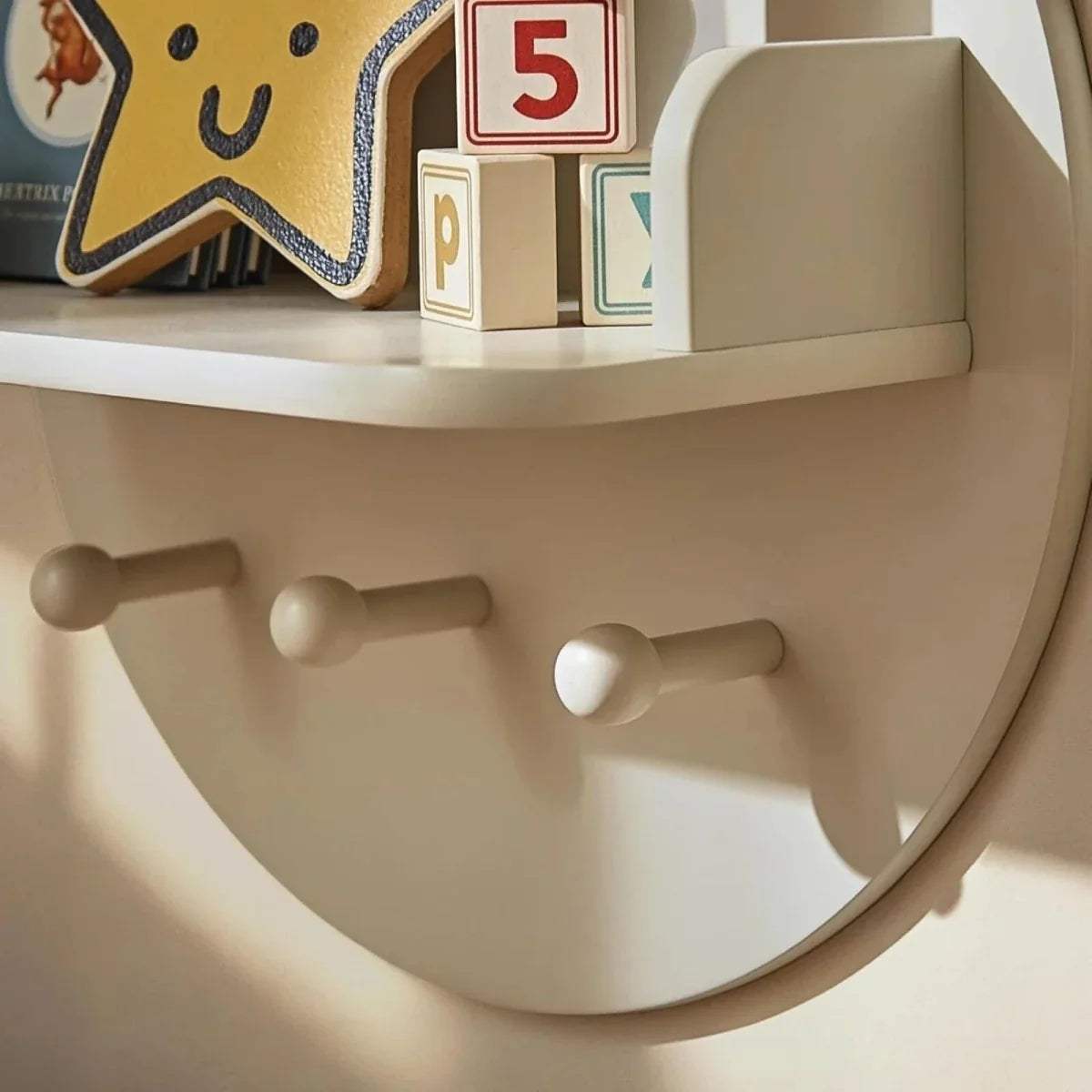 Pebble beige bear wall shelf with three round pegs on the lower panel