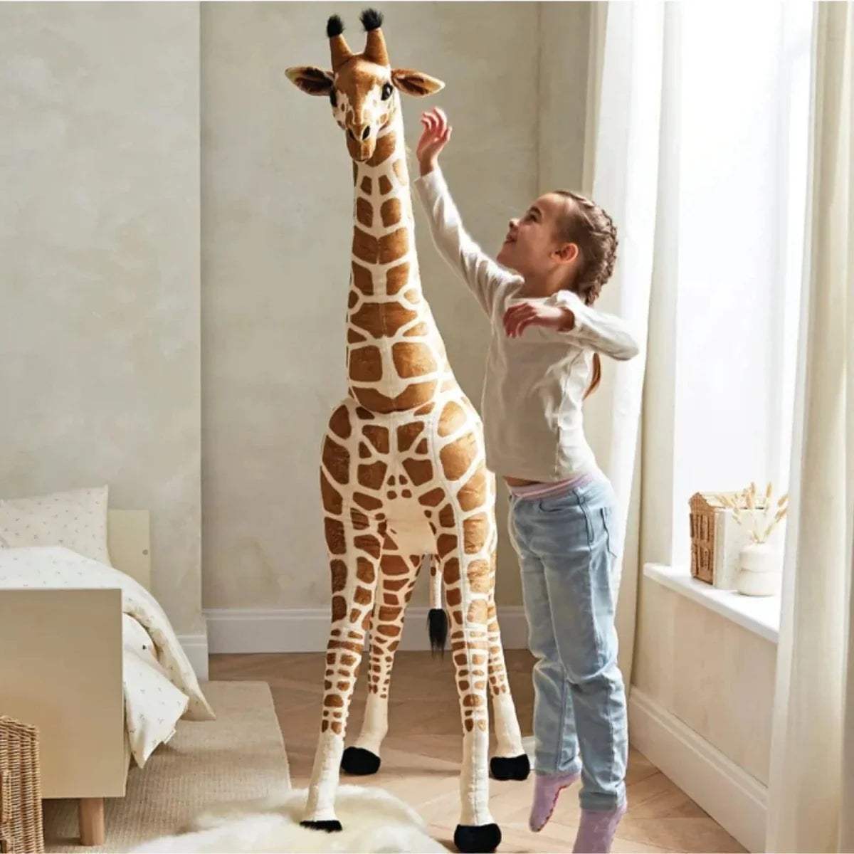 Standing plush giraffe with tall neck and brown-and-cream print next to a child.