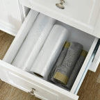 White pull-out drawer in a kitchen island cart with space for folded linens