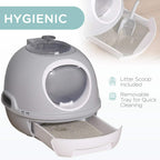 Grey enclosed cat litter box with removable lower tray and litter scoop next to it