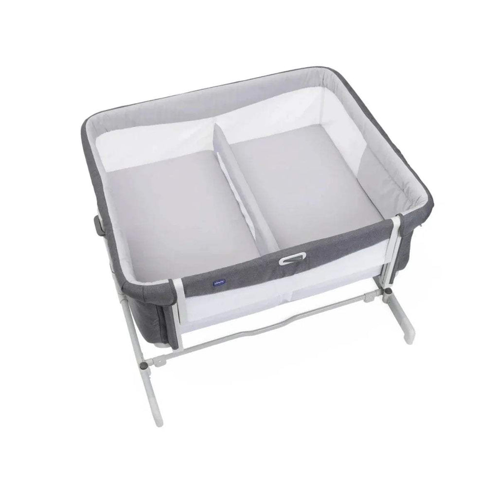 Magnet grey twin bedside crib from front-left, showing white inner mattress