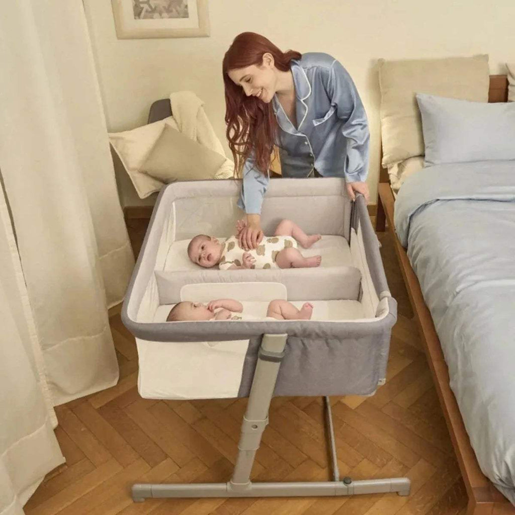 Magnet grey twin bedside crib on stand with padded inner sides and open top