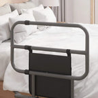 Black folding bed rail positioned over white bedding with front storage pocket panel.